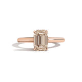 rose gold ring with a champagne emerald-cut diamond on a white background