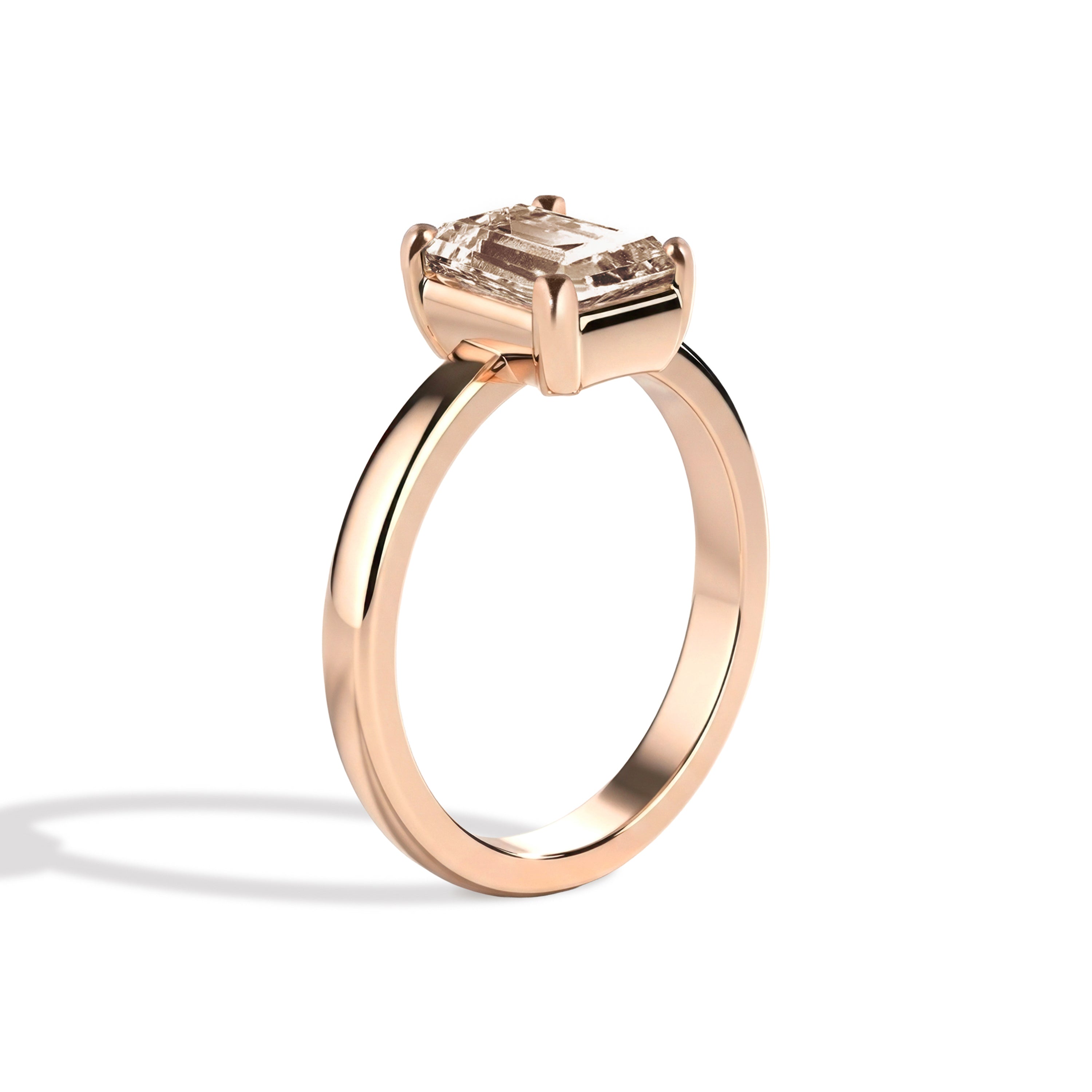 rose gold ring with a champagne emerald-cut diamond on a white background