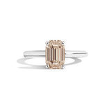 silver ring with a champagne emerald-cut diamond on a white background