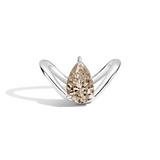 A pear-cut diamond ring set in a polished silver band, photographed on a clean white background with a soft shadow.