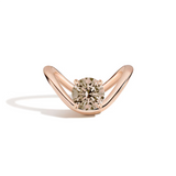 A rose gold ring with a curved, open curved shaped band and a round-cut diamond center stone, shown on a clean white background with a soft shadow.