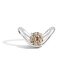 A silver curved solitaire ring featuring a round-cut champagne-colored center stone, set against a clean white background with a soft shadow.