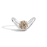 A silver curved solitaire ring featuring a round-cut champagne-colored center stone, set against a clean white background with a soft shadow.