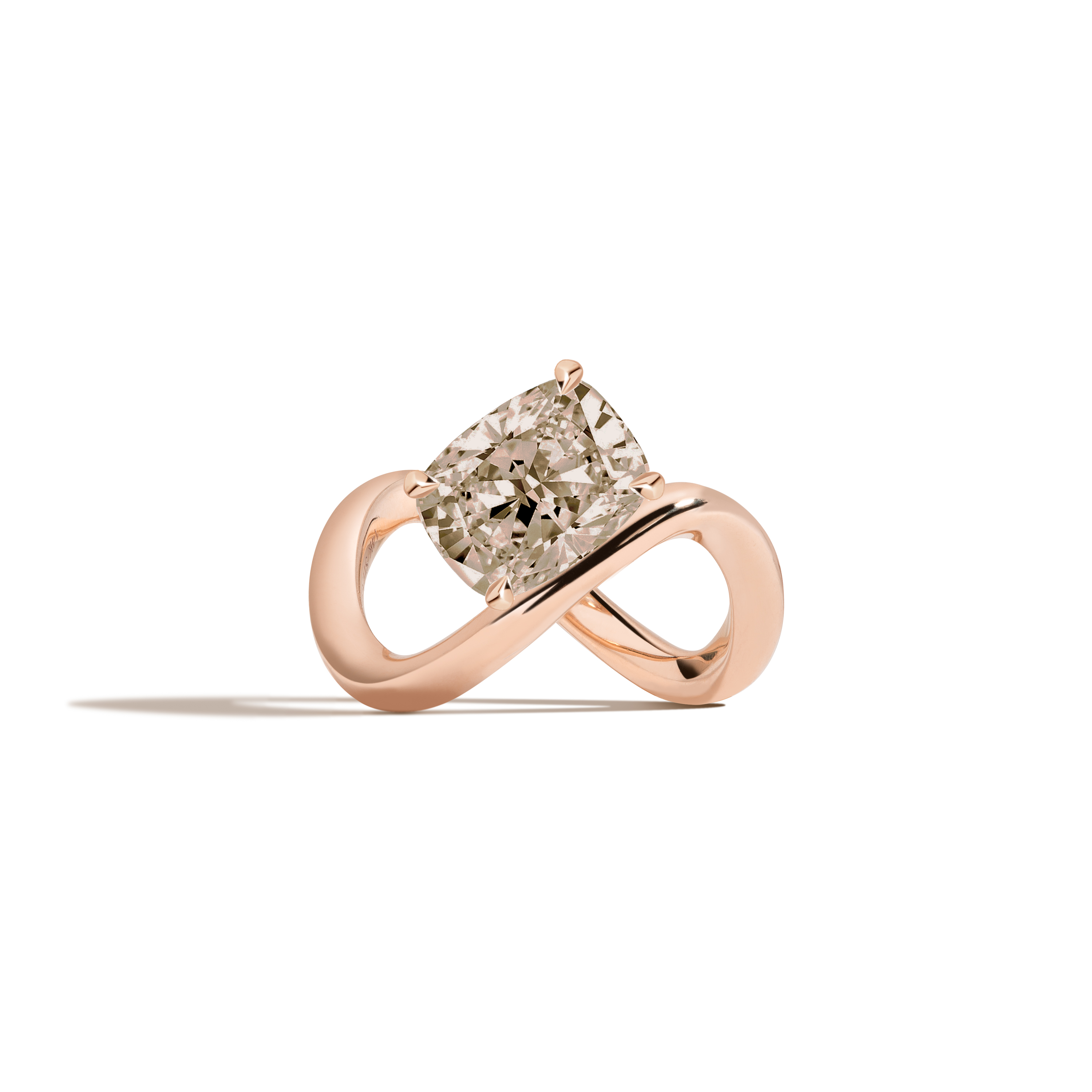 A rose gold infinity-shaped ring featuring a tilted cushion-cut champagne diamond center stone, set against a clean white background with a soft shadow.