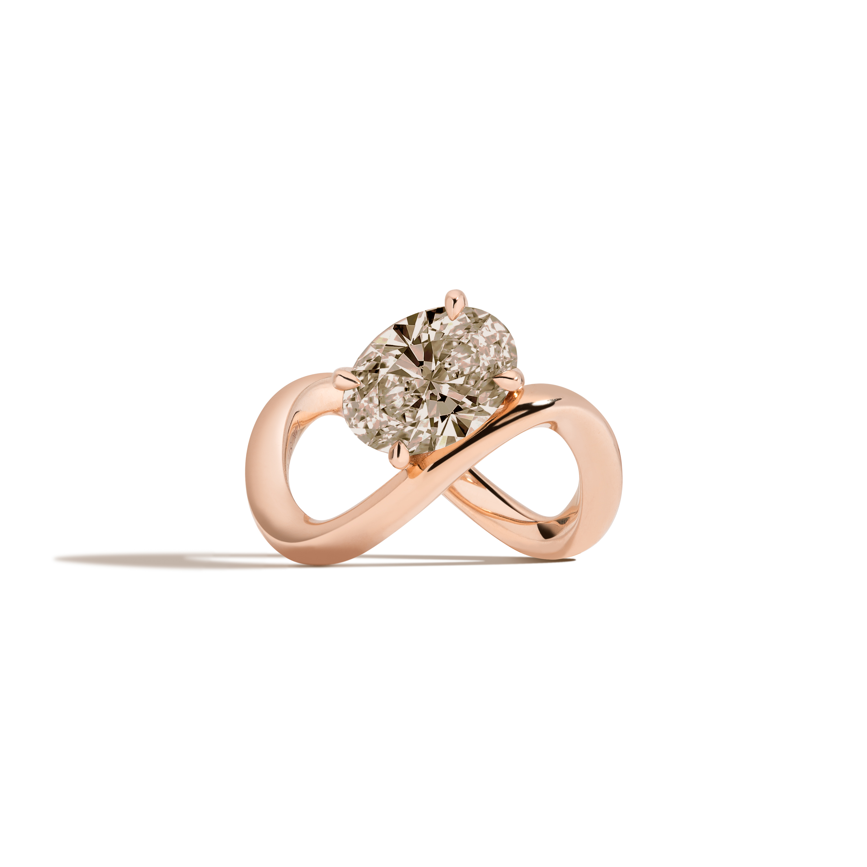 A rose gold infinity-shaped ring featuring a tilted oval champagne diamond center stone, set against a clean white background with a soft shadow.
