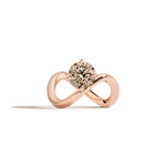 A rose gold infinity-shaped ring featuring a round champagne diamond center stone, set against a clean white background with a soft shadow.