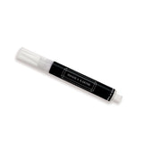 A pen-like jewelry cleaner with a black body and white cap, labeled 'Shahla Karimi'