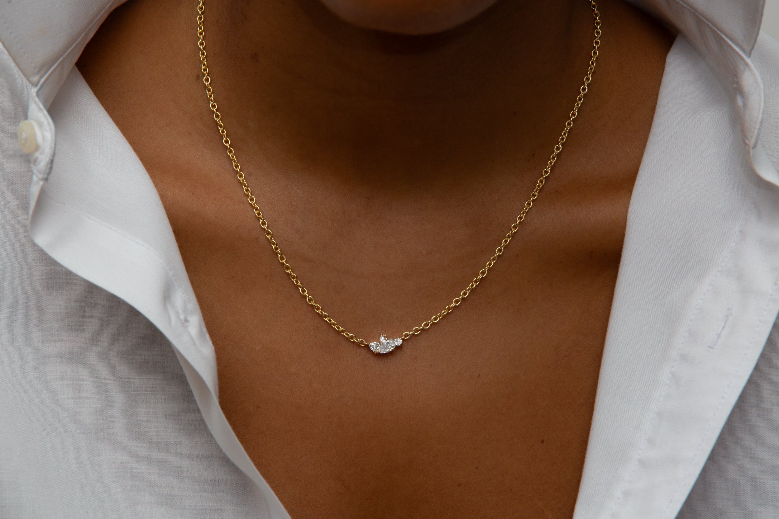 model wearing diamond necklace on gold chain