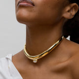 Person wearing 14k yellow gold and pear-cut diamond choker