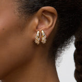 Close-up person wearing yellow gold Azadi Bombe Cluster Ear Arcs