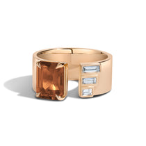 Yellow gold ring with citrine and white baguette-cut diamonds on white background