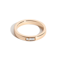 A gold band ring with diamonds set in a specific pattern to represent letters in Morse code.