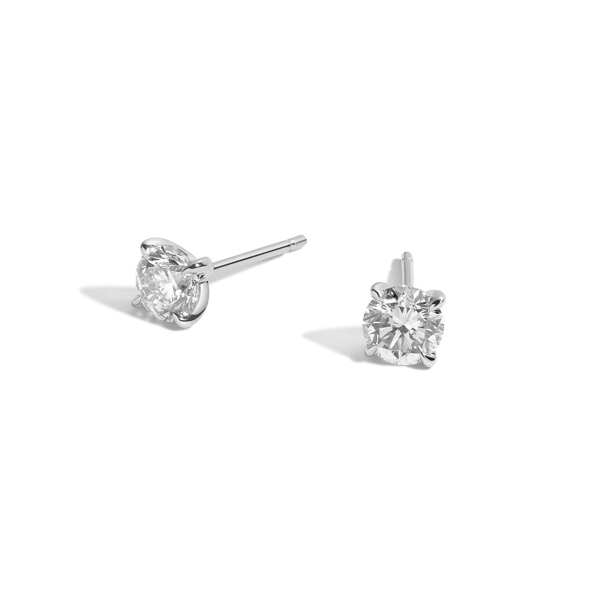 two diamond earrings on white background