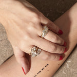 stacked engagement rings on hand with textured background