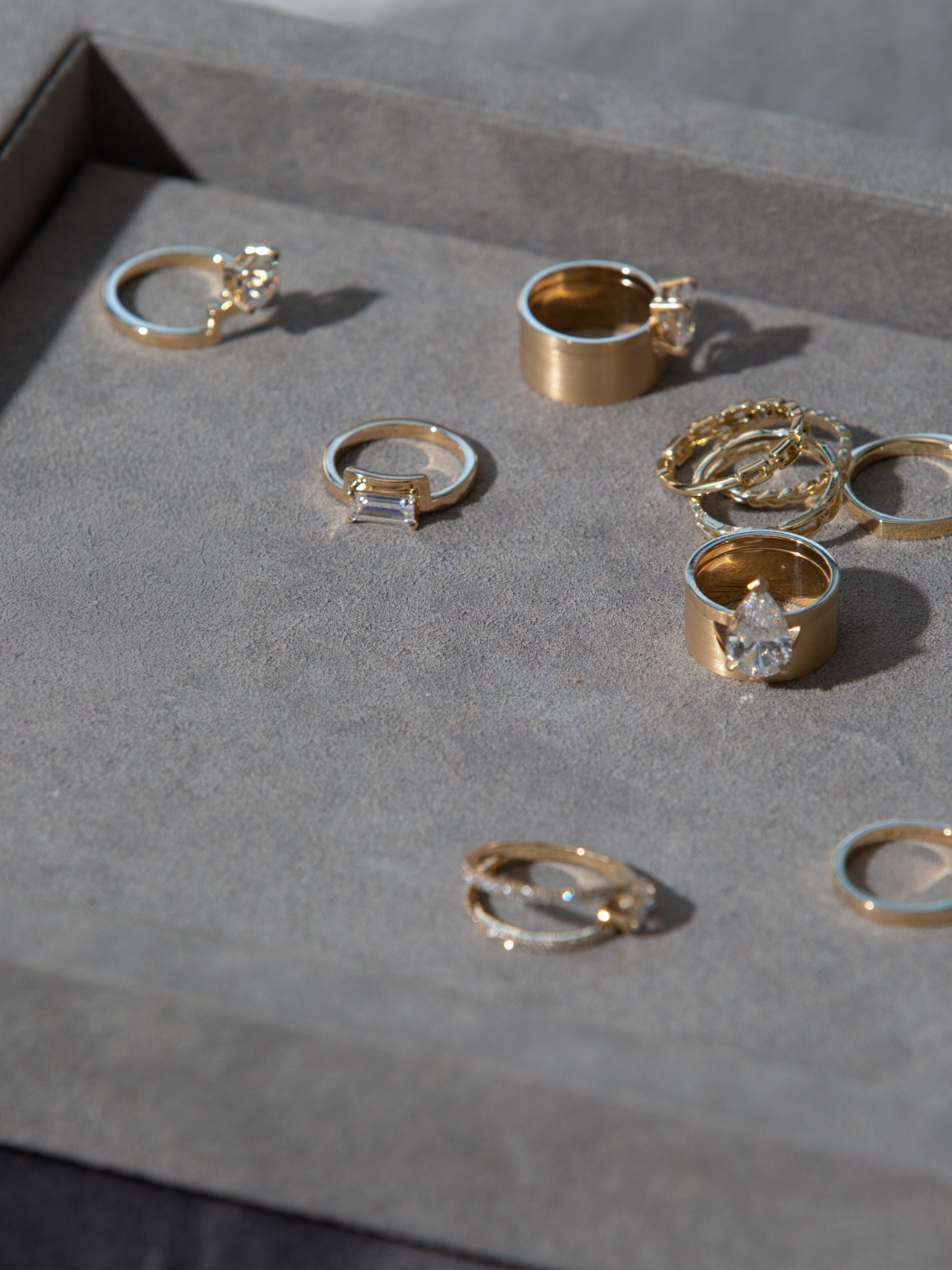 Collection of gold rings on a gray surface