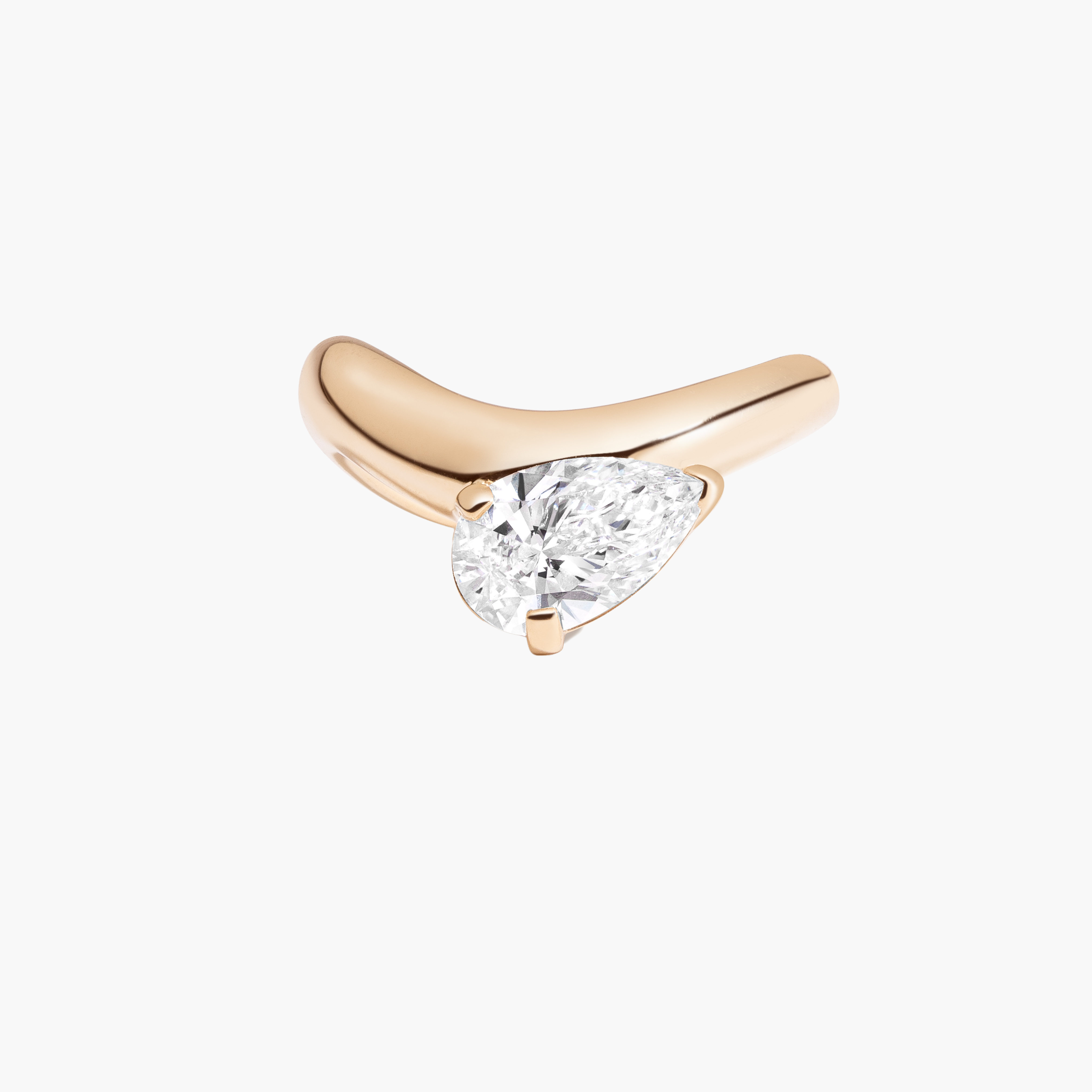 gold ring with a pear diamond on a white background