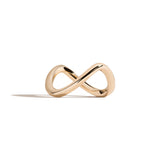 Gold infinity ring on a white background