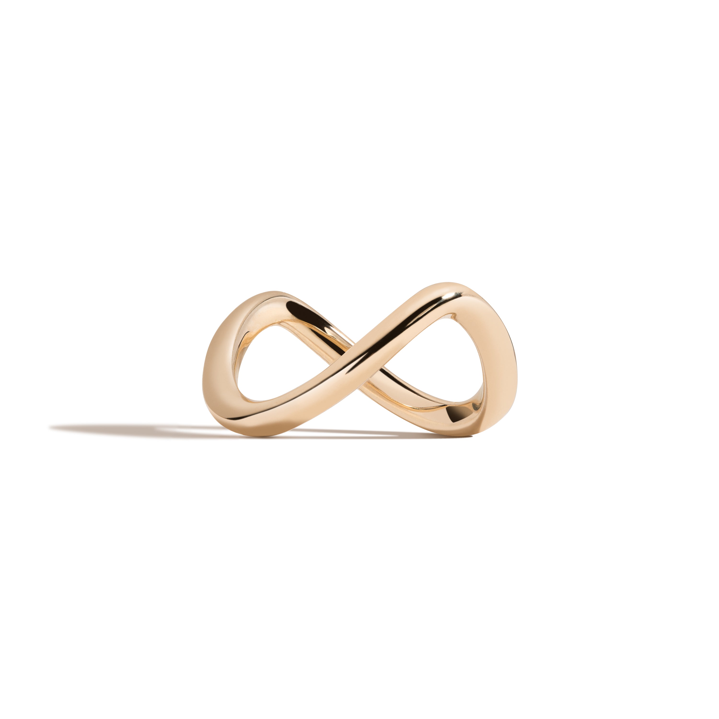 Gold infinity ring on a white background