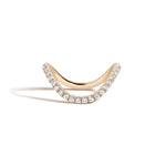 Yellow gold ring with pave diamonds on a white background