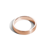 A 5mm wide, low-dome rose gold band ring with a horizontal satin finish.