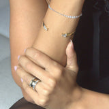 gold diamond rings and bracelet on model