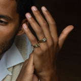 Rings in 14k yellow gold by Shahla Karimi on model on dark background