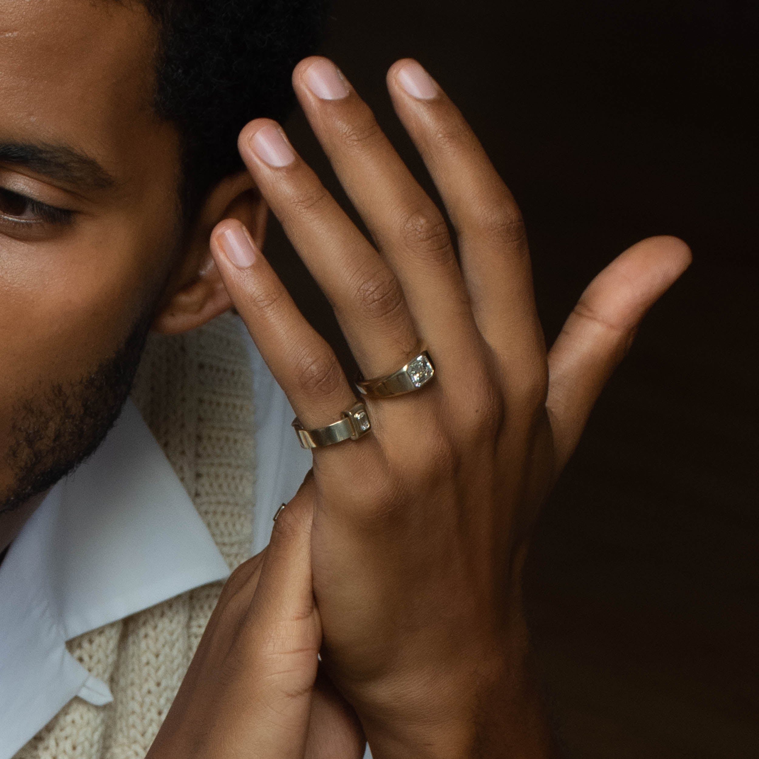 Rings in 14k yellow gold by Shahla Karimi on model on dark background