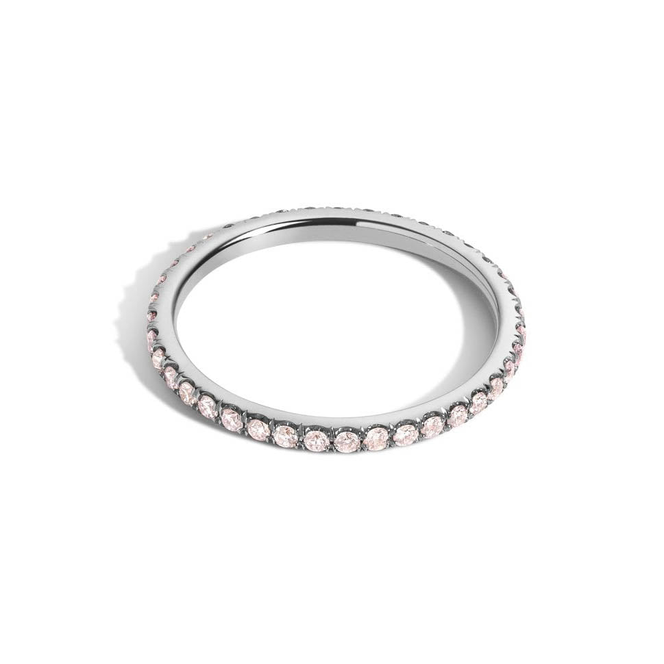 pink diamond eternity band on white gold on white background
