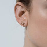 Shahla Karimi Jewelry Landmark Collection 14K Yellow Gold Chrysler Stud Earring with White Diamond Tapered Baguette on Model