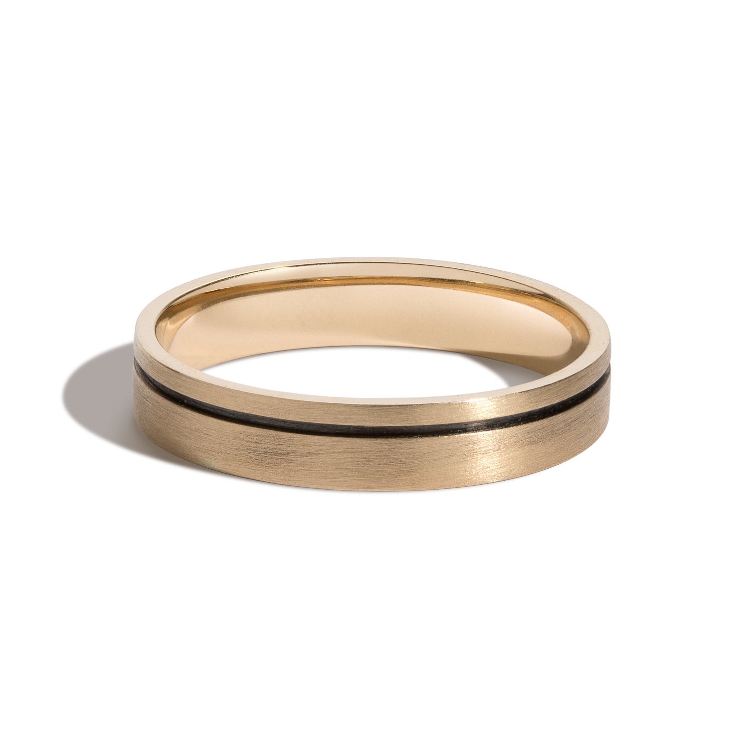 A 4mm black rhodium groove band ring with a gold-colored band and a groove carved 360° around it.