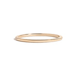simple thin yellow gold metal band on white background