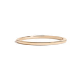 simple thin yellow gold metal band on white background