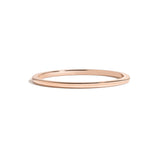 simple thin rose gold metal band on white background