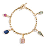 A gold-colored bracelet featuring a series of emerald-shaped links with various colored gemstones attached to the links.
